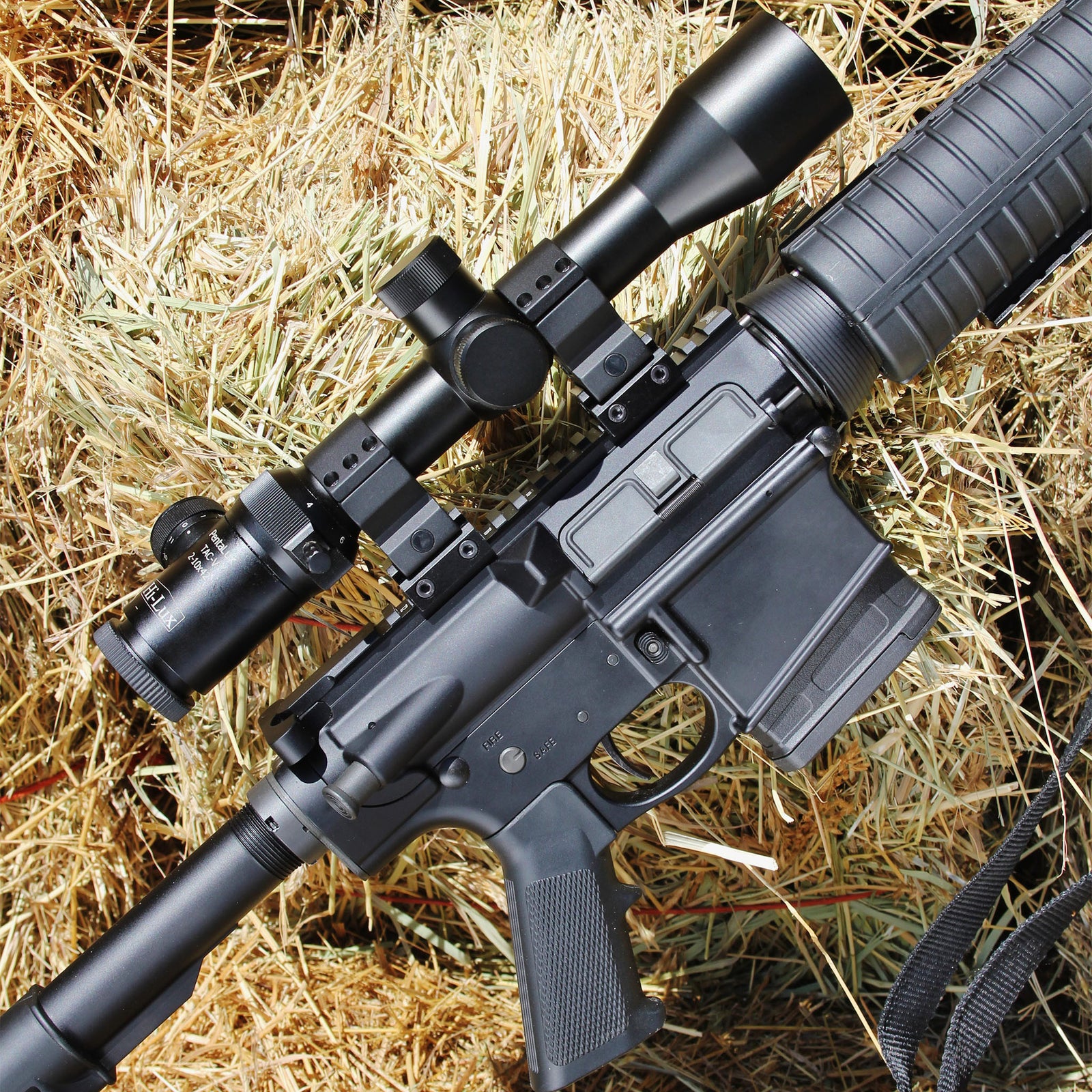 A pentalux scope mounted on an AR type rifle
