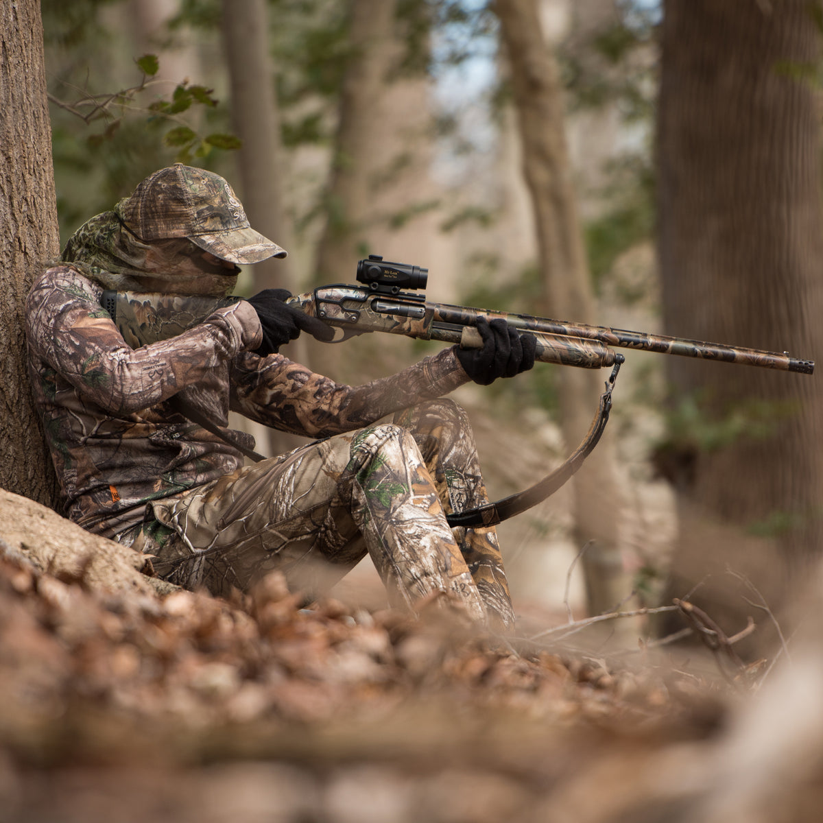 A hunter sits at the ready with a Tac Dot mounted on a shotgun