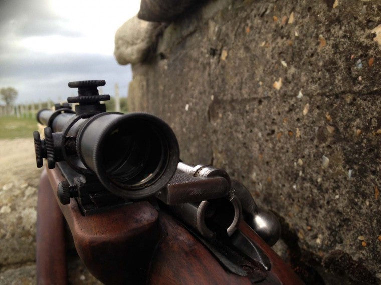 A malcolm short scope mounted offset on an old rifle