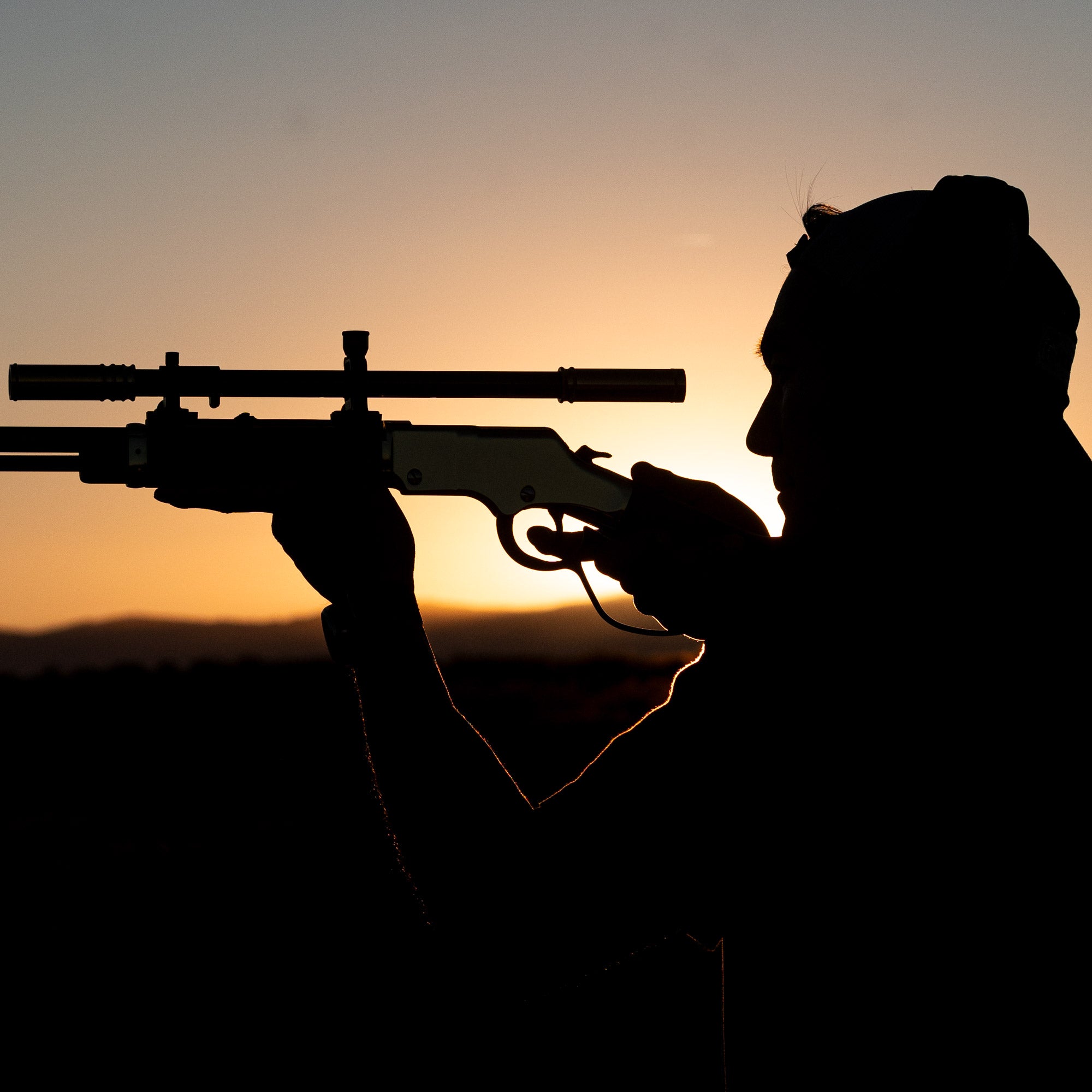 Malcolm 6X Short Two Tone scope atop an HGB, silhouetted against the sun