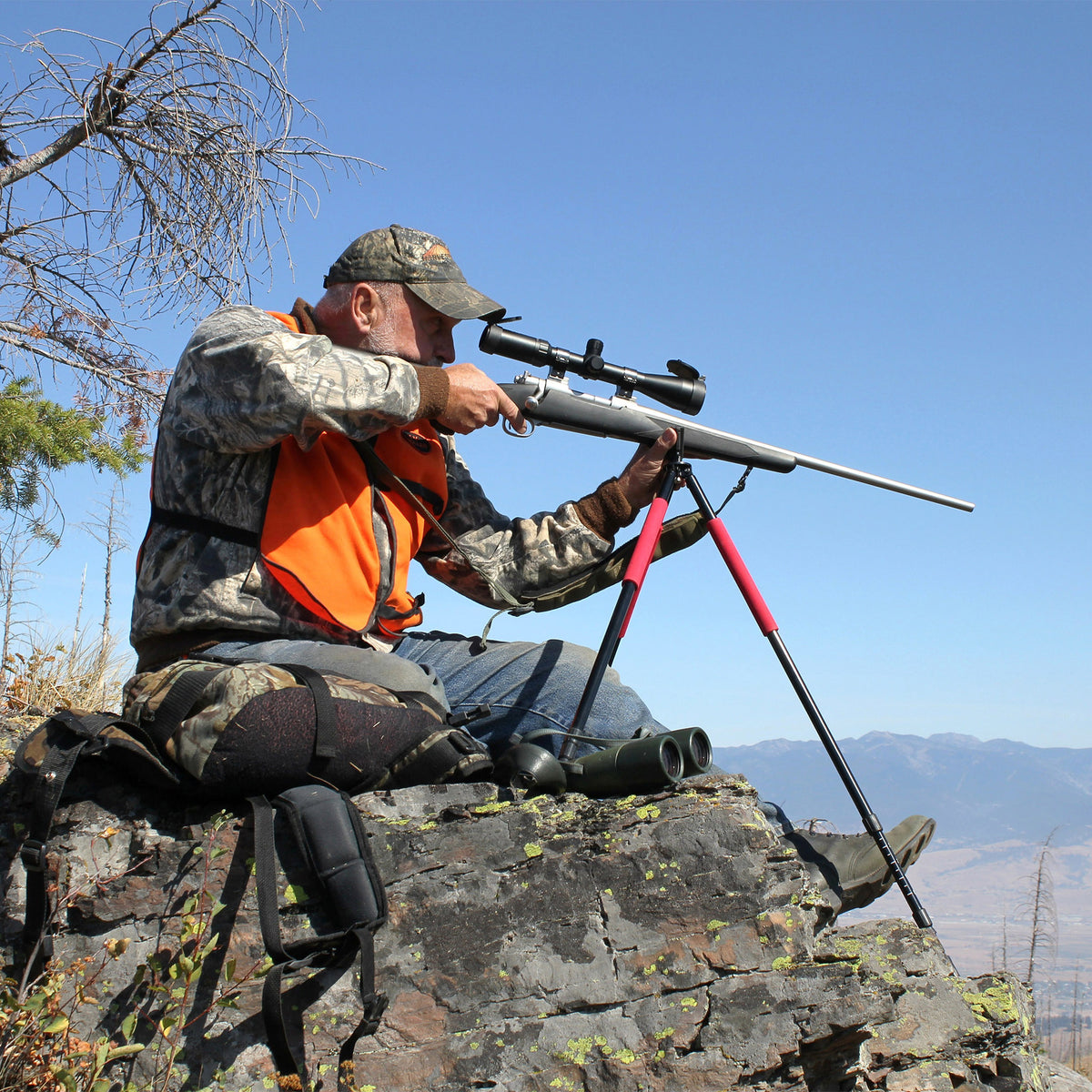 A hunter takes sight over a valley with his 30mm Scope
